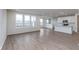 Open concept living area with wood-look floors, recessed lighting, and abundant natural light at 7151 Firestone Rd, Whitestown, IN 46052