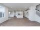 Bright, open-concept living space with wood-look flooring, white walls, and a kitchen island at 7151 Firestone Rd, Whitestown, IN 46052