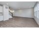 Spacious living area with wood-look flooring, neutral walls, and staircase at 7151 Firestone Rd, Whitestown, IN 46052