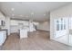 Spacious living room features modern kitchen, wood floors, and natural light from large sliding glass doors at 7151 Firestone Rd, Whitestown, IN 46052