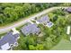 Stunning aerial view of an estate home, lush lawn, pool, golf course and mature trees at 780 Chatham Hills Blvd, Westfield, IN 46074