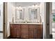 A primary bathroom featuring double sinks, custom wood cabinetry and framed mirrors at 780 Chatham Hills Blvd, Westfield, IN 46074