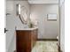 A serene bathroom featuring a wood vanity with granite countertops, neutral walls, and a uniquely framed mirror at 780 Chatham Hills Blvd, Westfield, IN 46074
