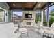 An outdoor covered porch with fireplace, grill, and comfortable seating at 780 Chatham Hills Blvd, Westfield, IN 46074