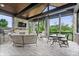 An outdoor covered porch with fireplace, grill, seating and dining table at 780 Chatham Hills Blvd, Westfield, IN 46074