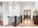 Bright foyer with hardwood floors, decorative light fixtures, and grand double doors at 780 Chatham Hills Blvd, Westfield, IN 46074