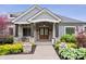 Stunning front entrance featuring a stone facade, wood columns, and a beautifully landscaped walkway at 780 Chatham Hills Blvd, Westfield, IN 46074