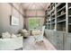 Home office featuring custom shelving, built-in desk, and a ladder for easy access to upper shelves at 780 Chatham Hills Blvd, Westfield, IN 46074