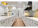 Gourmet kitchen features an expansive island, stainless appliances and sleek white cabinetry at 780 Chatham Hills Blvd, Westfield, IN 46074