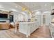 Open concept kitchen features a large island, white cabinets, and seamless flow into the living area at 780 Chatham Hills Blvd, Westfield, IN 46074