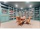 A cozy home library with custom bookshelves, ladder, and a round table at 780 Chatham Hills Blvd, Westfield, IN 46074