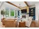 Bright living room with large windows, stone fireplace, and comfortable seating arrangement at 780 Chatham Hills Blvd, Westfield, IN 46074
