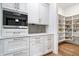 Custom butler's pantry includes built-in Miele coffee maker, and walk-in pantry with storage at 780 Chatham Hills Blvd, Westfield, IN 46074