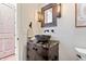 Stylish powder room with a vessel sink, unique lighting fixtures, and decorative accents at 780 Chatham Hills Blvd, Westfield, IN 46074