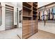 This walk-in closet features custom wood shelving with room for storing shoes, folded clothes, and hanging garments at 780 Chatham Hills Blvd, Westfield, IN 46074
