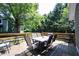 Back deck with wooden railing and black table and chairs at 8023 Talliho Dr, Indianapolis, IN 46256