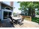 Back deck with a table and six chairs and a view of the backyard at 8023 Talliho Dr, Indianapolis, IN 46256