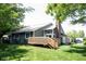 Backyard view highlighting the deck, brick chimney, and well-kept lawn, creating an inviting outdoor space at 8023 Talliho Dr, Indianapolis, IN 46256