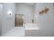 Bright bathroom featuring plank flooring, soaking tub, and glass enclosed shower at 8023 Talliho Dr, Indianapolis, IN 46256