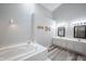 Bright bathroom features a soaking tub, double vanity, and contemporary finishes at 8023 Talliho Dr, Indianapolis, IN 46256