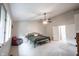 Spacious bedroom with vaulted ceiling, fan, neutral carpet, and bright windows at 8023 Talliho Dr, Indianapolis, IN 46256