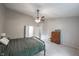 Spacious bedroom features a ceiling fan, neutral carpeting, and closet access at 8023 Talliho Dr, Indianapolis, IN 46256