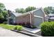 Charming home featuring brick accents, attached garage, manicured lawn, and vibrant flowering shrubbery at 8023 Talliho Dr, Indianapolis, IN 46256