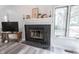 Living room fireplace with black tile and wooden mantle, complete with decor at 8023 Talliho Dr, Indianapolis, IN 46256
