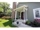 Inviting front porch and entrance to this beautiful home with brick chimney and garden at 8023 Talliho Dr, Indianapolis, IN 46256