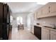 Bright kitchen features tile flooring, stainless steel sink, white cabinetry, and dining nook at 8023 Talliho Dr, Indianapolis, IN 46256