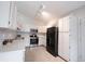 Well-lit kitchen featuring white cabinets, stainless steel appliances, and neutral finishes at 8023 Talliho Dr, Indianapolis, IN 46256