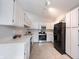 Bright kitchen features tile flooring, stainless steel appliances, and white cabinetry at 8023 Talliho Dr, Indianapolis, IN 46256