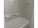 Tiled bathtub with painted white shelving and silver shower rod detail at 812 N California St, Indianapolis, IN 46202