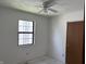 Bedroom featuring a window, ceiling fan, and closet at 812 N California St, Indianapolis, IN 46202