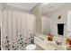 Bathroom features a vanity, toilet, shower with decorative curtain, and neutral decor at 8121 Bromley Pl, Indianapolis, IN 46219