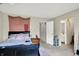 A cozy bedroom with a bed, bedside table, and doorway to the bathroom at 8121 Bromley Pl, Indianapolis, IN 46219