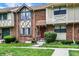 A brick townhome featuring a well-maintained front yard and a charming entrance at 8121 Bromley Pl, Indianapolis, IN 46219