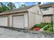 Attached garages for parking, with an asphalt driveway and partial landscaped area at 8121 Bromley Pl, Indianapolis, IN 46219