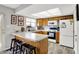 A bright kitchen with oak cabinets, stainless steel appliances, and breakfast bar at 8121 Bromley Pl, Indianapolis, IN 46219