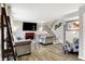 A cozy living room features hardwood floors, fireplace, staircase, and modern decor at 8121 Bromley Pl, Indianapolis, IN 46219