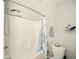 A tub and shower combination with a shower caddy, a grey towel, and toiletries at 813 Cottage Ave, Columbus, IN 47201