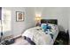 Bedroom featuring a lamp, a print, and a bed with blue and white covers at 813 Cottage Ave, Columbus, IN 47201