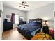 Comfortable bedroom features a ceiling fan and a bookcase headboard for storage at 813 Cottage Ave, Columbus, IN 47201