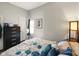 A bedroom with a black dresser, a window, and an artful wall painting at 813 Cottage Ave, Columbus, IN 47201