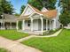 Charming single-story home boasting a welcoming front porch and well-maintained lawn at 813 Cottage Ave, Columbus, IN 47201