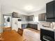 A spacious kitchen with gray cabinets, wood flooring, white refrigerator and appliances at 813 Cottage Ave, Columbus, IN 47201