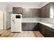 Bright kitchen with grey cabinets, wood flooring, a white refrigerator and light countertops at 813 Cottage Ave, Columbus, IN 47201