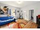 Cozy living room with wood floors, a colorful rug, and a bright window at 813 Cottage Ave, Columbus, IN 47201