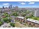 An aerial view showcasing the building, surrounding neighborhood, and city skyline at 855 N East N St # 104-B, Indianapolis, IN 46202