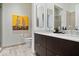 Modern bathroom featuring double sinks, dark wood cabinets, stylish mirrors and neutral paint at 855 N East N St # 104-B, Indianapolis, IN 46202
